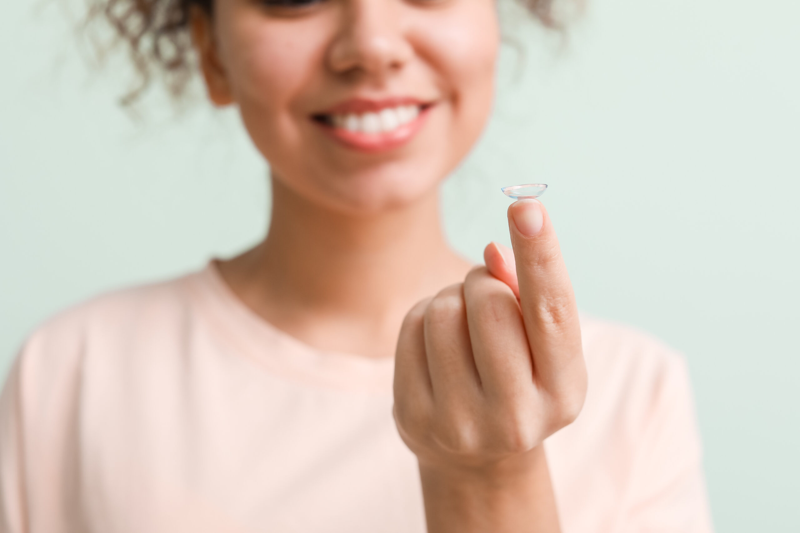 Lady holding a contact lens 